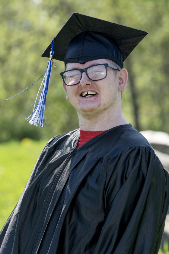 A photo of Maywood Academy graduate Jacob Baker in his cap and gown.