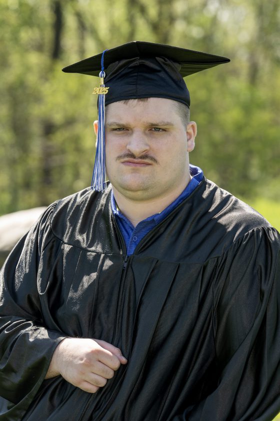 A photo of Maywood Academy graduate Joseph Toubman in his cap and gown.