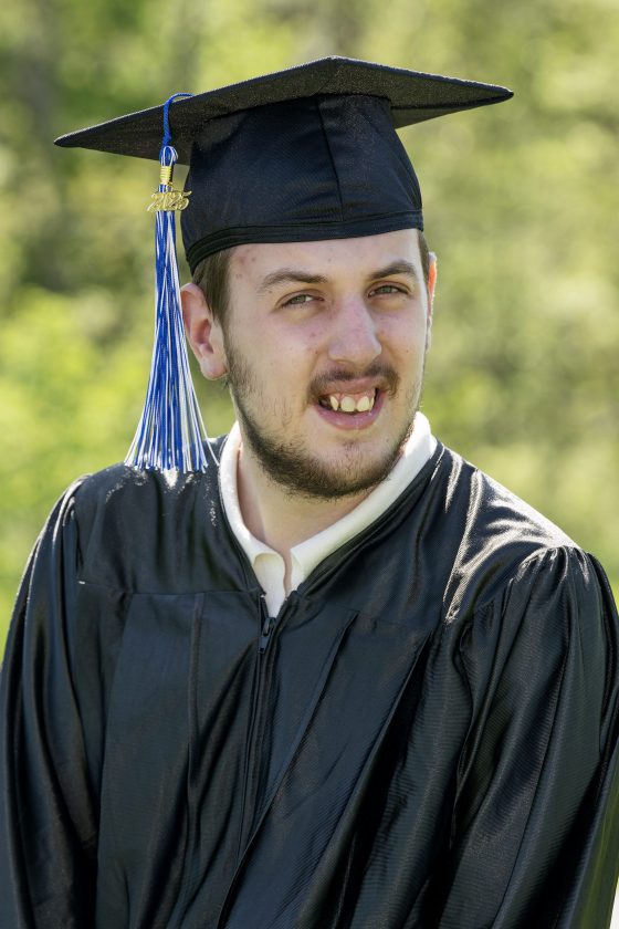 A photo of Maywood Academy graduate Raymond Janicke in his cap and gown.