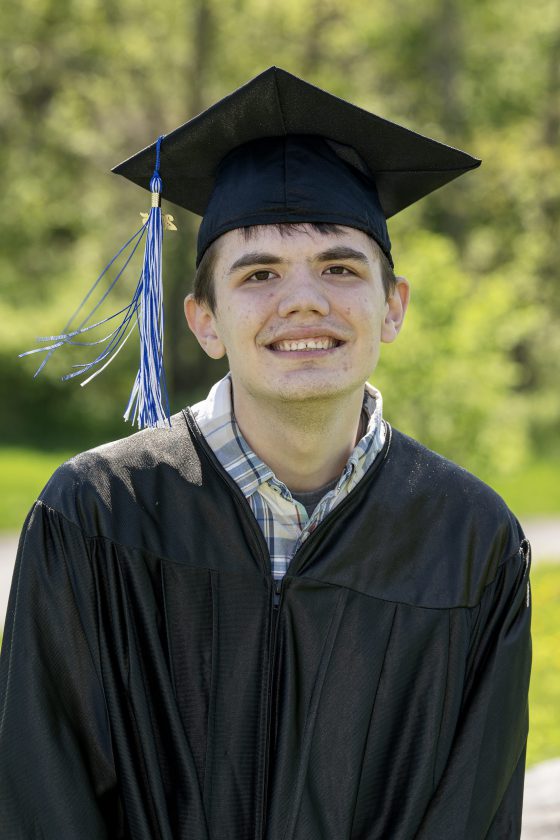 A photo of Maywood Academy graduate Jacob Angus in his cap and gown.