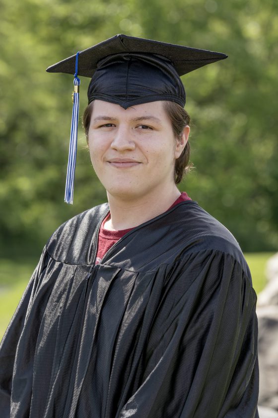 A photo of Maywood Academy graduate Isaiah Melendez in his cap and gown.