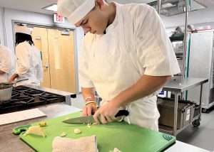 Student cutting onions