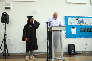 Graduate Daireem Tibbs stands with teacher Roberto Biasiucci during the June 13 graduation ceremony.