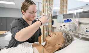 Student works on a mannequin 