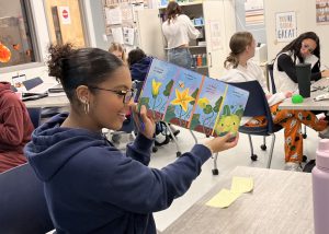 Student reads a book to kids