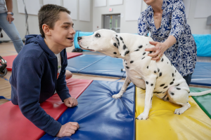 Jamie Smith Quinn, executive director of the FASNY Museum of Firefighting  introduces a student to Molly the Museum Dog.