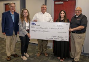 Representatives from Capital Region BOCE and BBL gather for a photo while holding a large $25,000 check. 