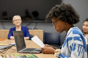 CTE & DHH student Temani Thompson sits along side author Constance Clarke and NERIC training specialist for the recordings of the book narrations.
