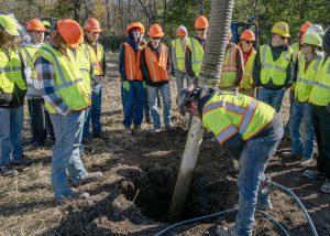 Students watch a hydrovac in action