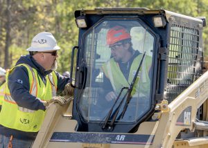 Student in a bobcat with a business rep