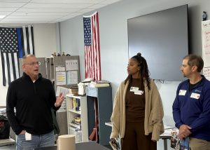 Teacher talks to guests on a tour