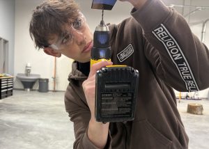 A student with a drill