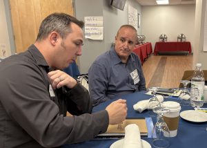 Teacher and business person speak