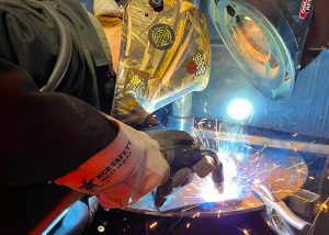 A female student welds