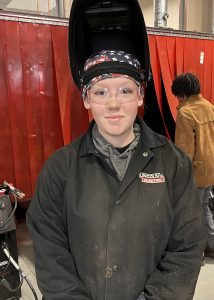 Female welding student poses 