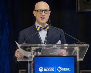 A man speaks at a podium