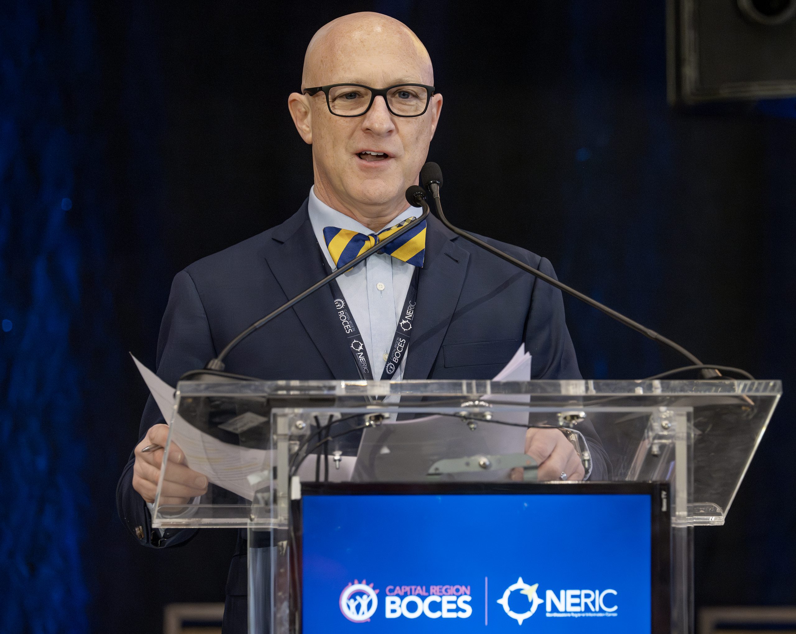 A man speaks at a podium