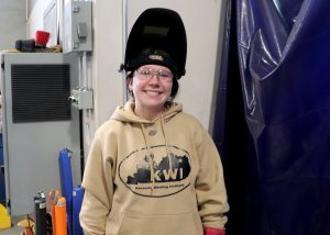 student smiles and poses