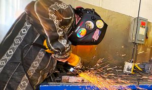Sparks fly as student grinds metal