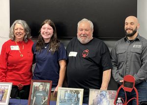 Student poses with family and teacher
