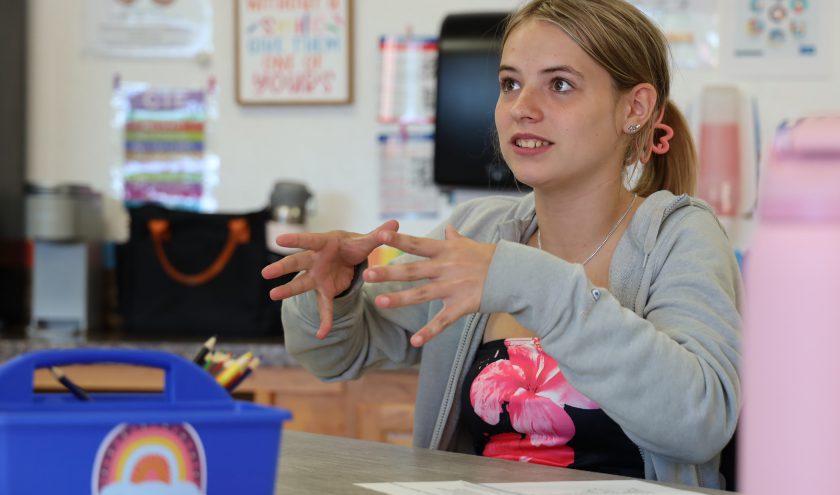 A nursing student practices taking a patient's blood pressure.