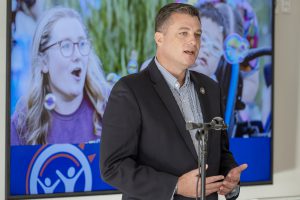 New York State Senator Jacob Ashby stands at the podium to deliver remarks.