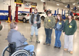 TA talksto prospects in the auto lab