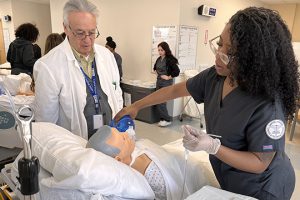 Teacher and student with a mannequin 