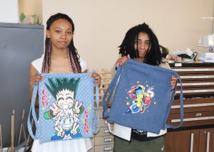 2 students pose with their bag