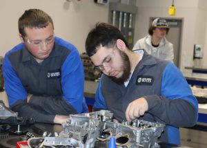 Students work on an engine