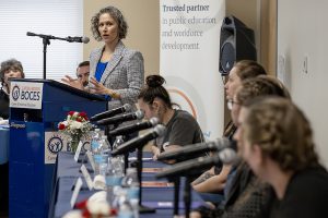 Speaker looks at panel