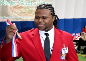 Student looking at his medal
