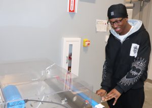 Student smiles while working with technology