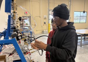 Student plugs a cord in