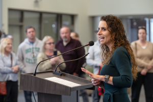 Close up photo of Karen Swain, Capital Region BOCES Assistant District Superintendent for Curriculum and Instruction, as she delivers the opening reception speech to a crowd of CRB staff, student artists, their families and teachers. 