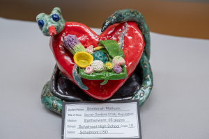 A close up photo of a heart sculpture that is on display at the Student Art Show. 