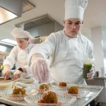 Culinary students add the finishing touches to a meal.
