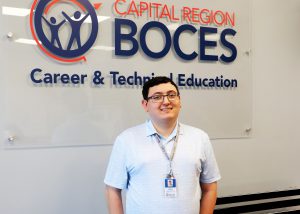 A pic of Antonio in front of a CRB sign