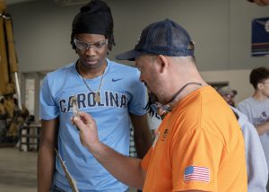 Contractor helping a student