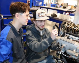 students repair an engine