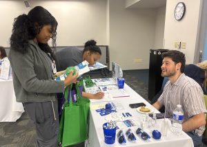 A student talks with a recruiter over a table
