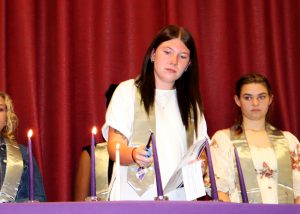 student lights candle