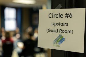 Close up photo of a sign directing students to their discussion circle. 