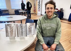 Wyatt next to trophies