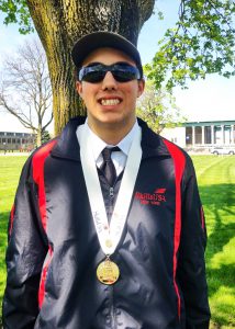 Boy poses with medal and sunglasses 