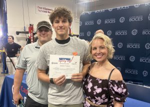 Student poses with family