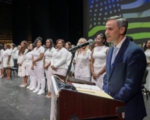 Principal speaks while students look on