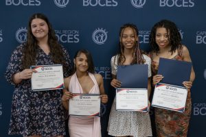 four girls pose with certificstes