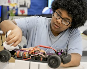 STEM student working on a car