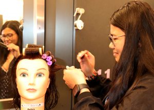 Girl smiling while styling hair